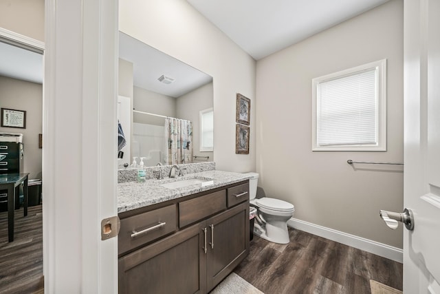 full bathroom with visible vents, wood finished floors, baseboards, vanity, and toilet