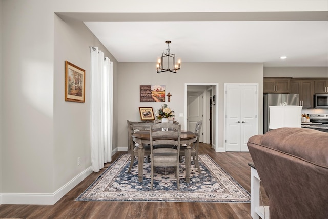 dining area featuring dark wood-type flooring, recessed lighting, baseboards, and a notable chandelier