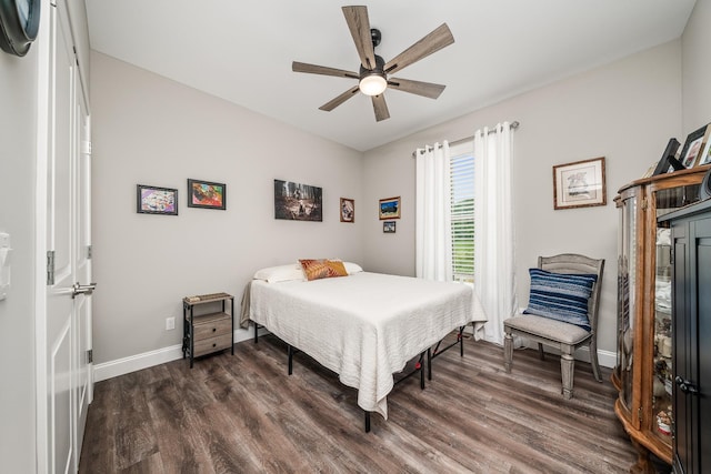 bedroom with baseboards, dark wood finished floors, and ceiling fan