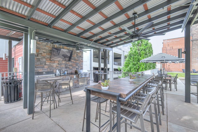 view of patio / terrace featuring area for grilling, ceiling fan, outdoor dining area, and a grill
