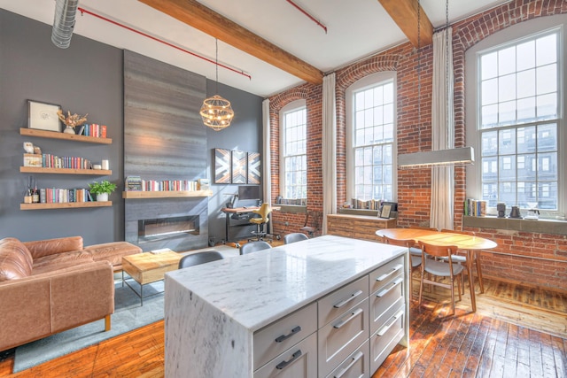 kitchen featuring plenty of natural light and brick wall