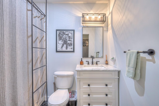 bathroom featuring toilet, curtained shower, and vanity