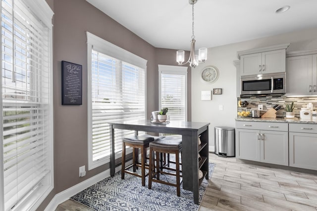 1132 Upland Ter, Clarksville, TN 37043 - dining room featuring baseboards, light wood finished floors, and a chandelier