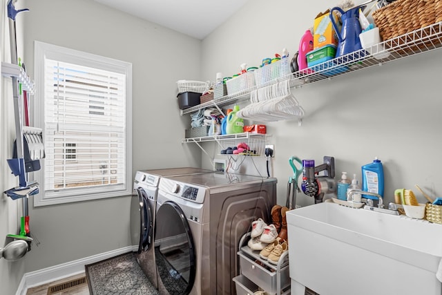 1132 Upland Ter, Clarksville, TN 37043 - laundry room with laundry area, visible vents, a sink, baseboards, and washer and dryer