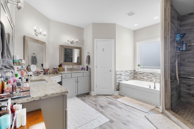 1132 Upland Ter, Clarksville, TN 37043 - full bathroom featuring vanity, a bath, wood finished floors, and tiled shower