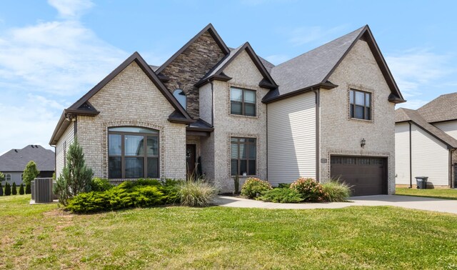 1132 Upland Ter, Clarksville, TN 37043 - view of front of home with an attached garage, cooling unit, concrete driveway, and brick siding