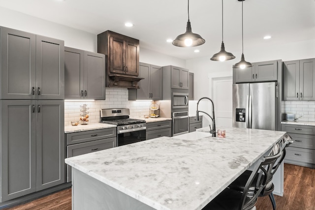 kitchen featuring appliances with stainless steel finishes, decorative backsplash, gray cabinets, and recessed lighting