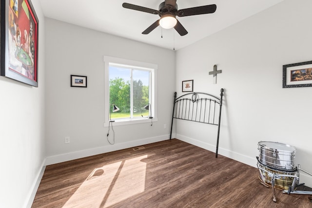 unfurnished bedroom featuring baseboards, a ceiling fan, and wood finished floors