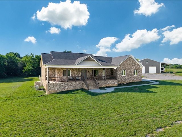single story home with a porch, a garage, and a front yard