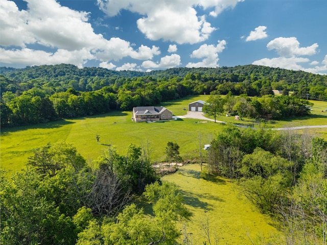 aerial view featuring a view of trees and a rural view