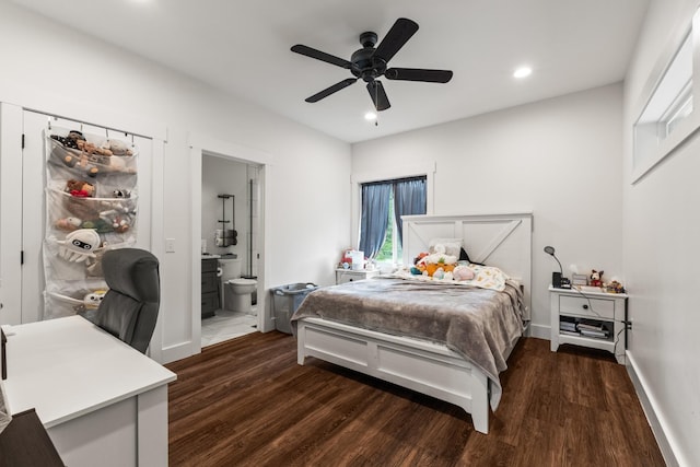 bedroom with baseboards, ensuite bath, recessed lighting, and wood finished floors