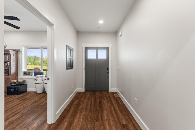 doorway to outside with baseboards, ceiling fan, and wood finished floors