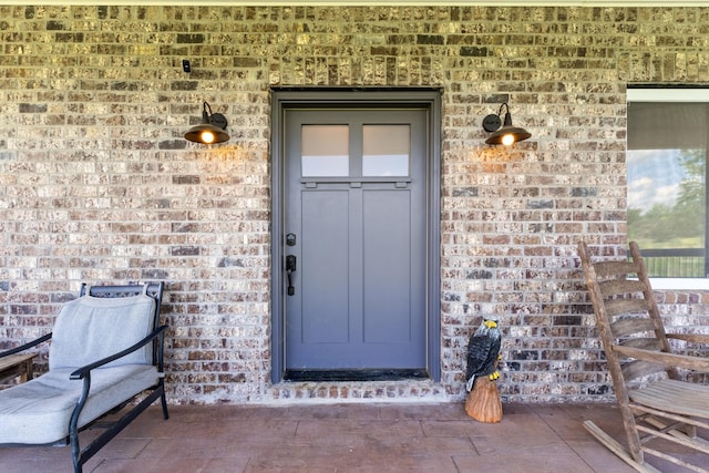 property entrance featuring brick siding