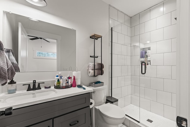 bathroom with vanity, ceiling fan, a stall shower, and toilet