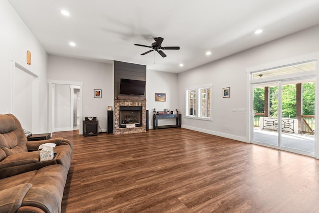 living area with dark wood-style flooring, a fireplace, recessed lighting, a ceiling fan, and baseboards