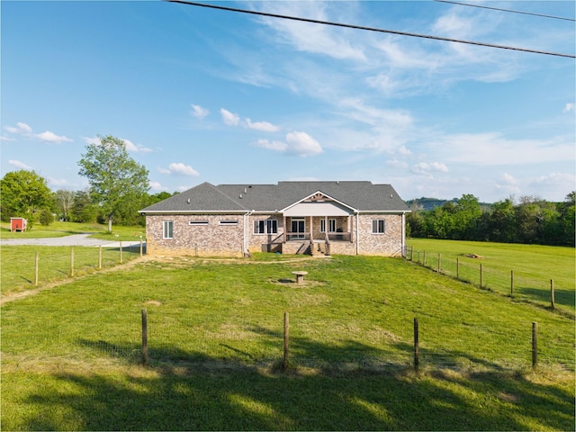 back of house featuring a lawn and a fenced backyard