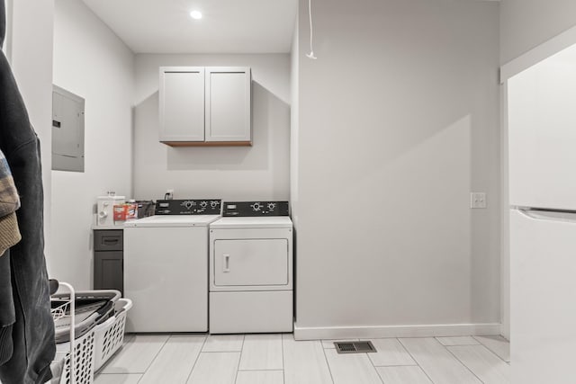 washroom featuring visible vents, recessed lighting, electric panel, separate washer and dryer, and cabinet space