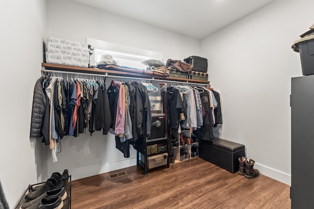 walk in closet with visible vents and wood finished floors