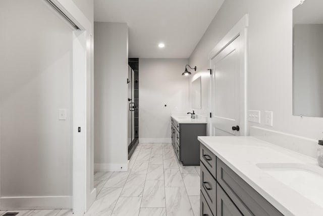 full bath with a stall shower, two vanities, baseboards, marble finish floor, and recessed lighting