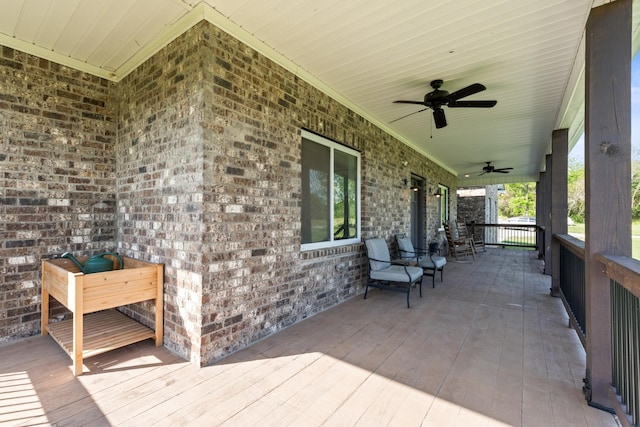 wooden terrace featuring a ceiling fan and a porch