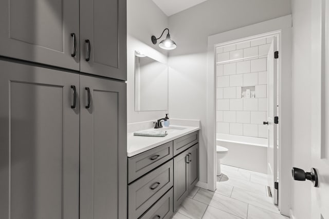 full bath featuring vanity, marble finish floor, bathtub / shower combination, and toilet