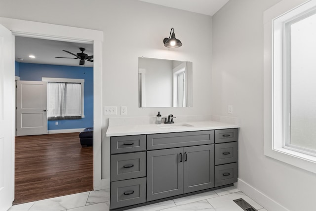 bathroom featuring vanity, marble finish floor, a ceiling fan, baseboards, and recessed lighting