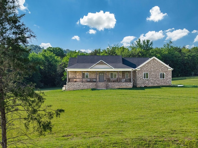 ranch-style house with covered porch, brick siding, and a front lawn