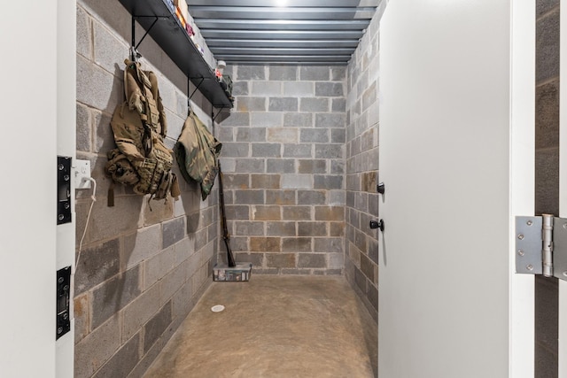 bathroom featuring concrete block wall