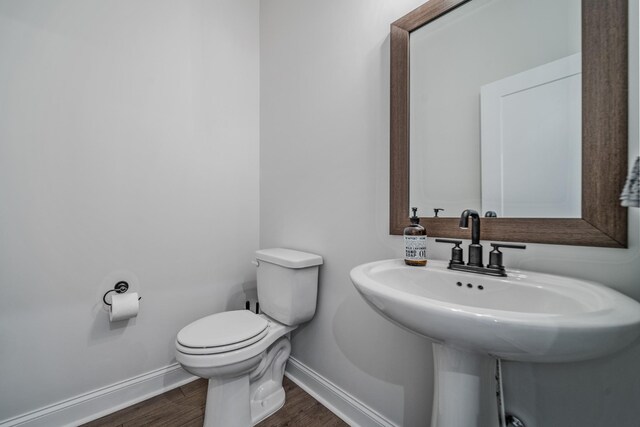 1055 Inez Dr, Smyrna, TN 37167 - half bath featuring baseboards, wood finished floors, toilet, and a sink