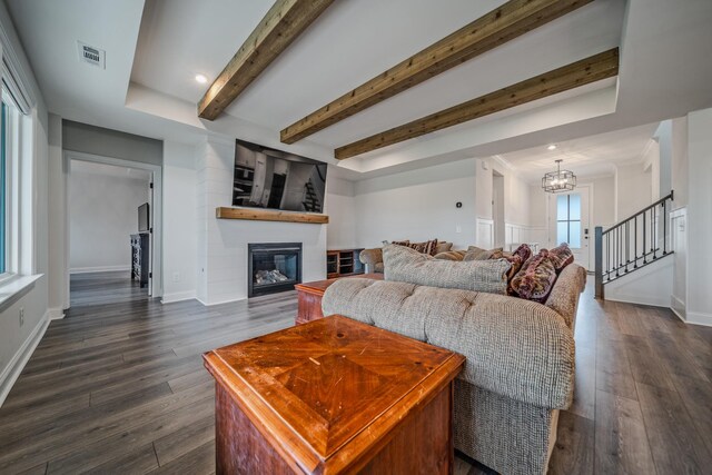 1055 Inez Dr, Smyrna, TN 37167 - living room featuring a large fireplace, healthy amount of natural light, beamed ceiling, a chandelier, and dark wood-style flooring