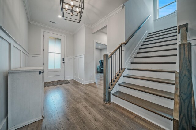 1055 Inez Dr, Smyrna, TN 37167 - foyer entrance with stairway, crown molding, plenty of natural light, a decorative wall, and dark wood-type flooring