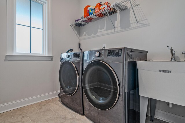 1055 Inez Dr, Smyrna, TN 37167 - laundry room with washing machine and clothes dryer, baseboards, and tile patterned floors