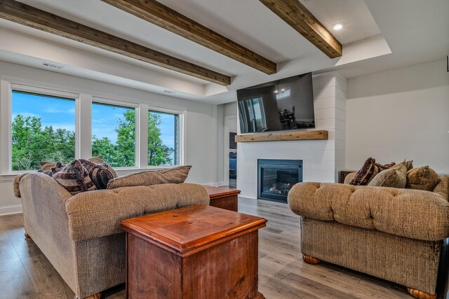 1055 Inez Dr, Smyrna, TN 37167 - living room featuring wood finished floors, a glass covered fireplace, and beam ceiling