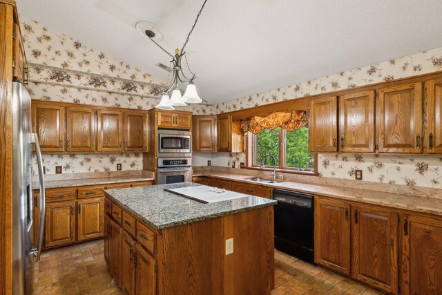 1314 Huntington Dr, Columbia, TN 38401 - kitchen featuring a sink, appliances with stainless steel finishes, brown cabinetry, and wallpapered walls