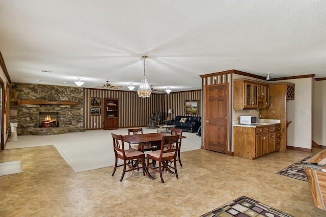 1314 Huntington Dr, Columbia, TN 38401 - dining area featuring crown molding, a fireplace, ceiling fan with notable chandelier, and a textured ceiling