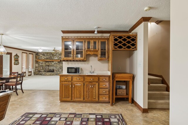 1314 Huntington Dr, Columbia, TN 38401 - bar featuring ornamental molding, stairway, a textured ceiling, a sink, and wet bar