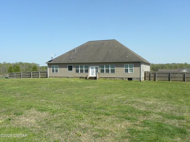 85 Neshova Ln, Henderson, TN 38340 - rear view of house with entry steps, a yard, and a fenced backyard