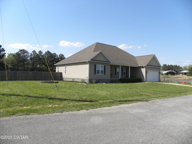 85 Neshova Ln, Henderson, TN 38340 - ranch-style house with a garage, fence, driveway, and a front yard