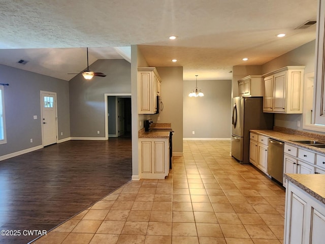 85 Neshova Ln, Henderson, TN 38340 - kitchen with appliances with stainless steel finishes, ceiling fan with notable chandelier, open floor plan, lofted ceiling, and visible vents