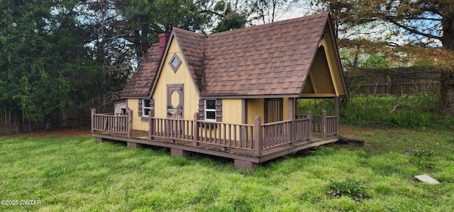 85 Neshova Ln, Henderson, TN 38340 - back of house featuring fence, a wooden deck, a shingled roof, and a yard