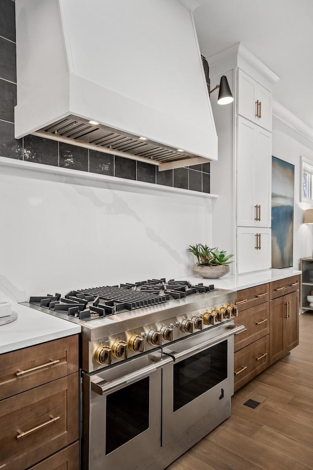 7258 Murrel Dr, Franklin, TN 37064 - kitchen with wood finished floors, custom exhaust hood, white cabinets, and double oven range