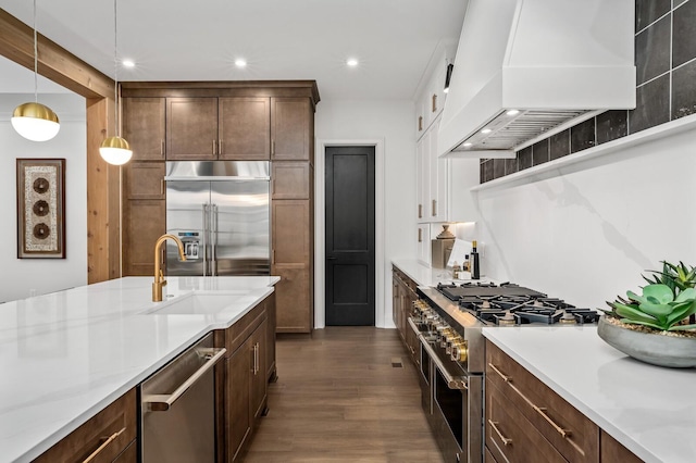 7258 Murrel Dr, Franklin, TN 37064 - kitchen featuring high quality appliances, pendant lighting, a sink, premium range hood, and dark wood-type flooring