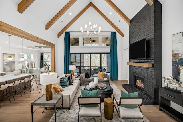 7258 Murrel Dr, Franklin, TN 37064 - living room with a brick fireplace, wood finished floors, high vaulted ceiling, beamed ceiling, and an inviting chandelier