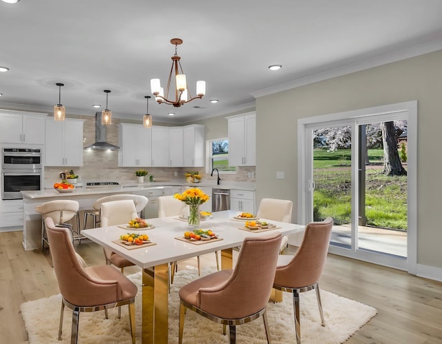 dining room with crown molding, recessed lighting, a notable chandelier, and light wood-type flooring