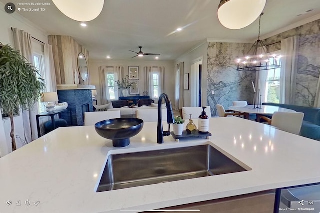 152 Salton Ln, Spring Hill, TN 37174 - kitchen featuring a sink, ceiling fan with notable chandelier, open floor plan, light countertops, and a fireplace