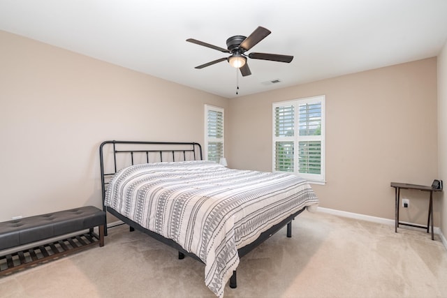 bedroom featuring carpet floors, baseboards, a ceiling fan, and visible vents
