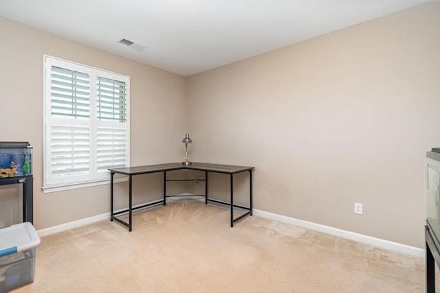 unfurnished office featuring baseboards, carpet flooring, and visible vents