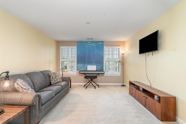 living room featuring baseboards, visible vents, and light colored carpet