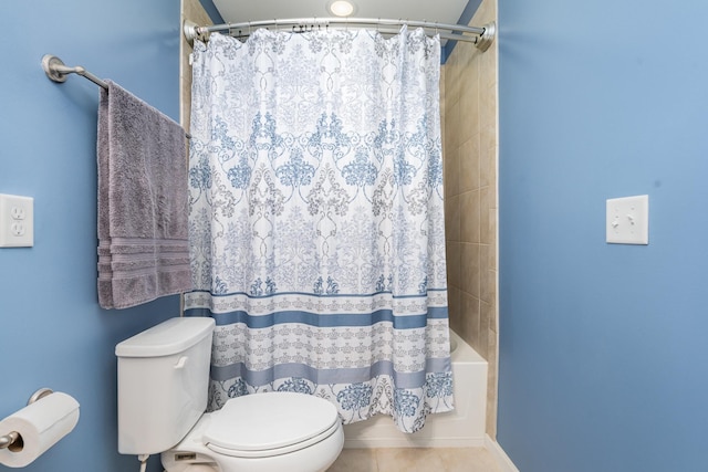 full bath with tile patterned floors, shower / bath combo with shower curtain, and toilet