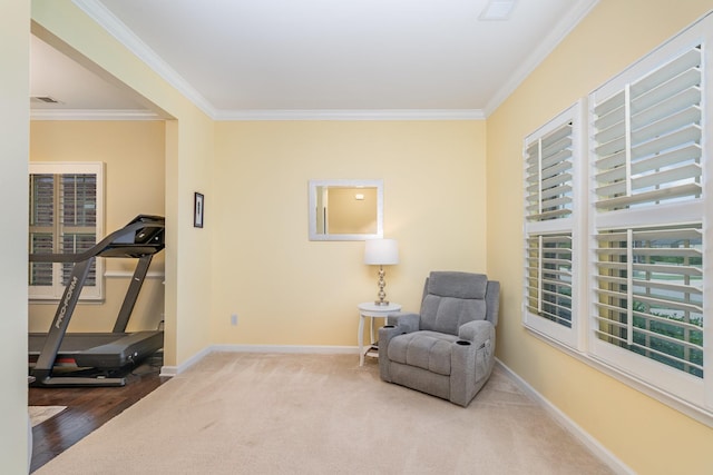 living area featuring baseboards, ornamental molding, carpet floors, and wood finished floors
